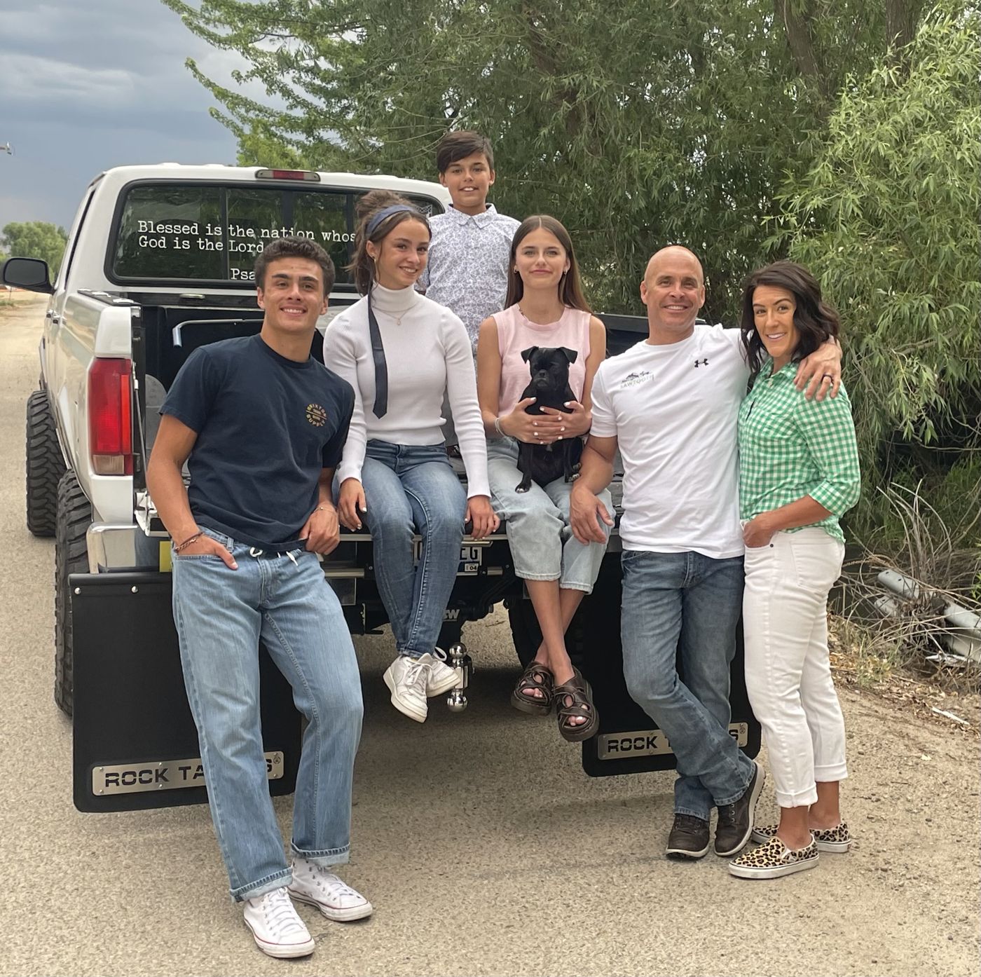 Paul Redondo and his family sitting on the tailgate of his truck