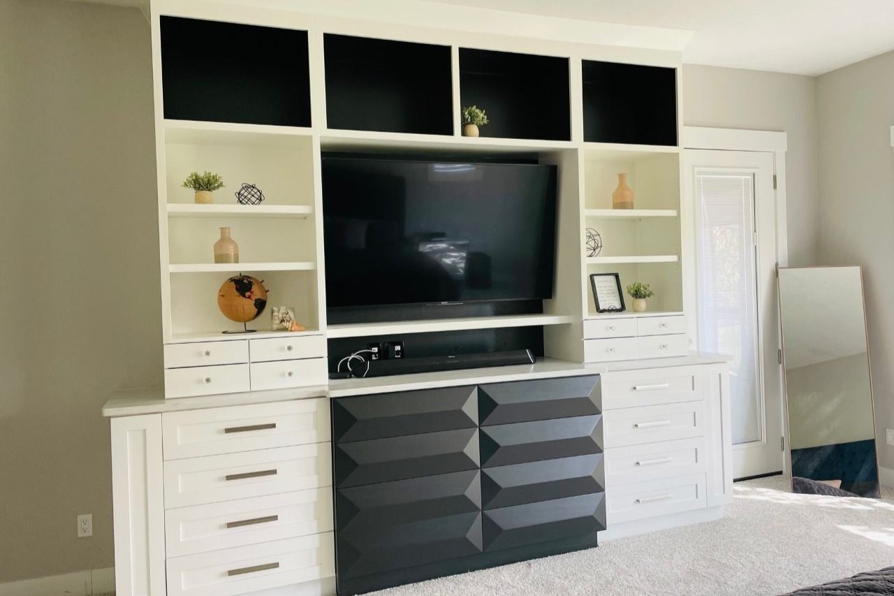White built-in entertainment wall with black lower drawers